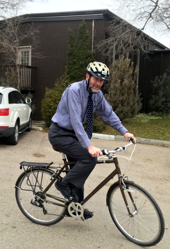 Dr. Brian Graham, riding a bicycle to work.