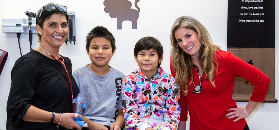 Doctor and nurse with young asthma patients