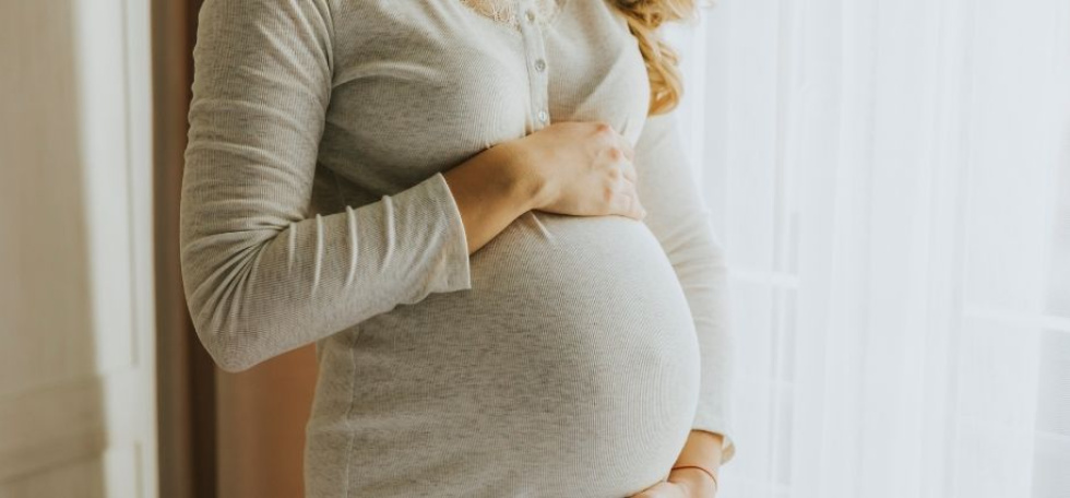 Pregnant woman holding her belly