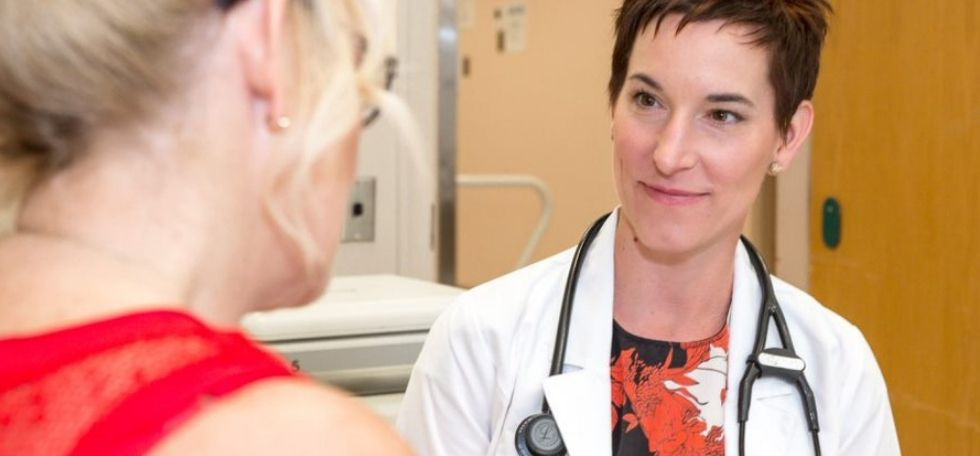 Dr. Penz listening to patient